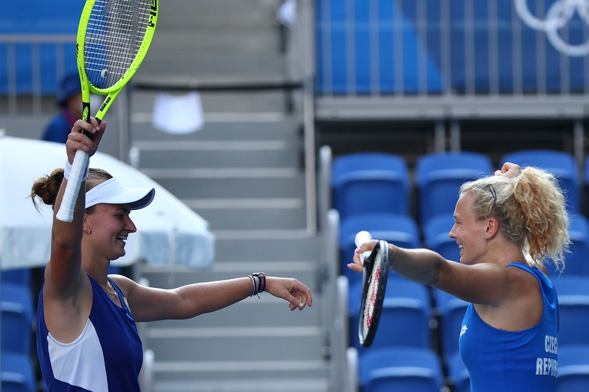 The Czech Republic's Katerina Siniakova and Barbora Krejcikova celebrate after winning their Olympics women's doubles gold medal match against Switzerland's Viktorija Golubic and Belinda Bencic.