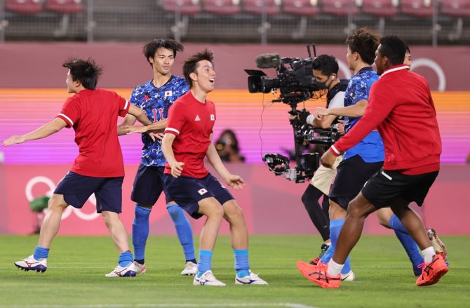 Kaoru Mitoma celebrates with teammates after Japan defeat New Zealand in the penalty shoot-out to enter the Olympics men's football semi-finals, on Saturday.