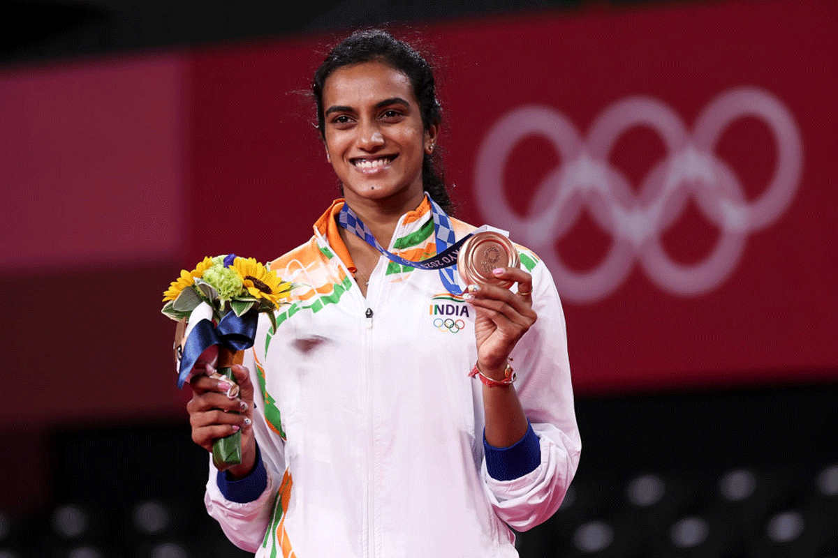 Bronze medallist, India's PV Sindhu poses on the podium during the medal ceremony for the Women’s Singles badminton event at the Tokyo Olympics, on Sunday