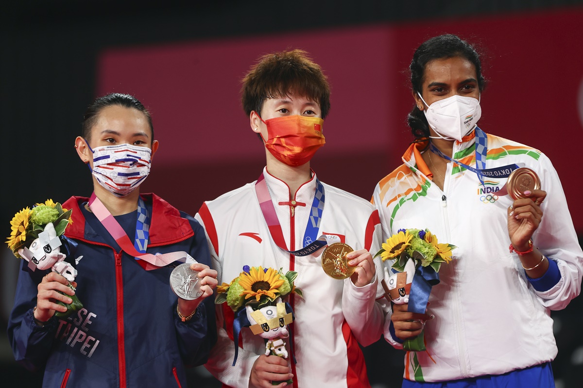 Gold medallist Chen Yufei of China, silver medallist Tai Tzu-Ying of Taiwan and bronze medallist P V Sindhu of India pose with their medals won from the women's singles badminton at the Tokyo Olympics on Sunday.
