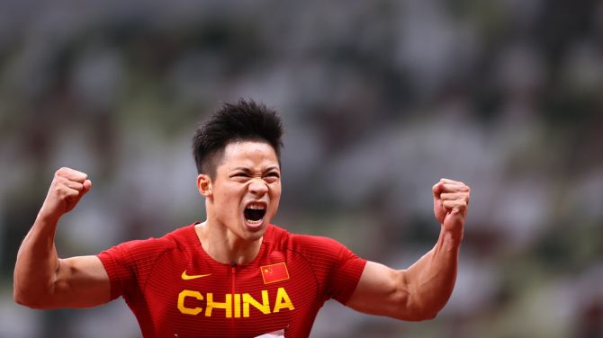 China's Su Bingtian celebrates after winning his Olympics men's 100 metres semi-final, at Olympic stadium, Tokyo, on Sunday.