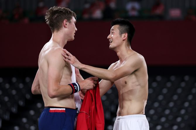 Denmark's Viktor Axelsen, left, is congratulated by his opponent Chen Long of China after winning the Olympics men’s singles badminton gold