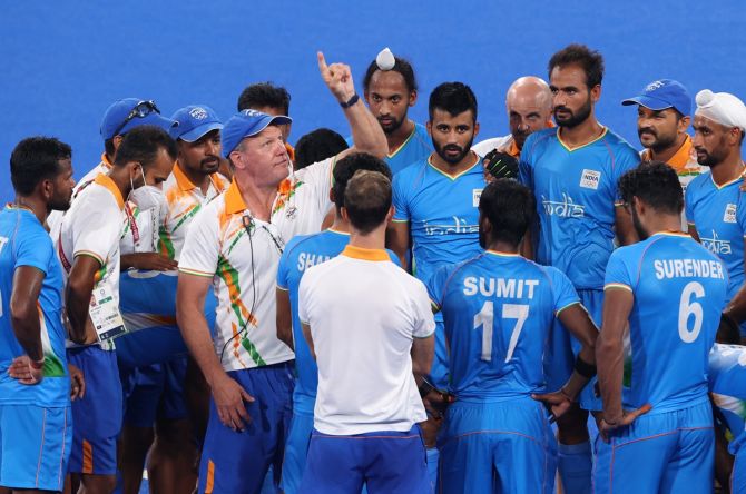India's head coach Graham John Reid speaks with his players following victory over Great Britain in the Olympics men's hockey quarter-final, at Oi Hockey Stadium in Tokyo, on Sunday. 