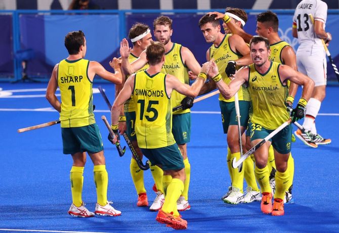 lake Govers is congratulated by teammates after putting Australia ahead during the Olympics men's hockey semi-final against Germany. 