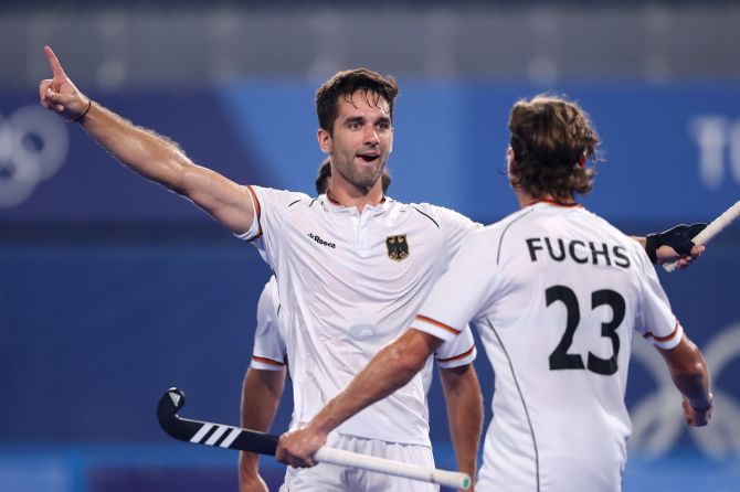 Lukas Windfeder celebrates with teammate Florian Fuchs after scoring for Germany