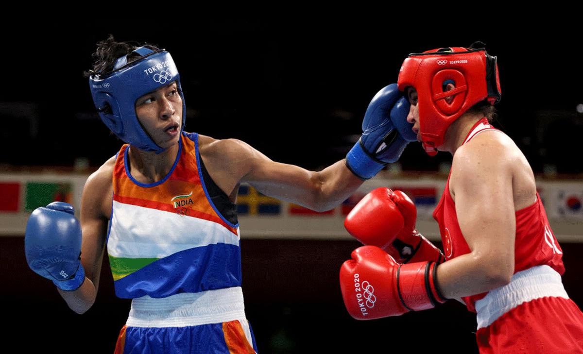 India's Lovlina Borgohain punches Turkey's Busenaz Surmeneli (red) during their Women's Welterweight (64-69kg) boxing semi-final at Kokugikan Arena in Tokyo, Japan, on Wednesday