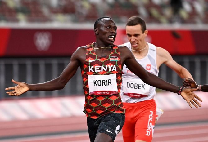 Kenya's Emmanuel Kipkurui Korir celebrates crossing the finish line to win gold ahead of bronze medallist Patryk Dobek of Poland in the men's 800 metres final. 