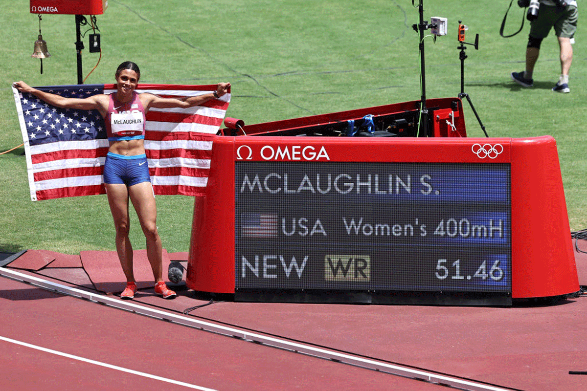 USA'S Gold medalist Sydney McLaughlin poses in front of the scoreboard after setting a new world record in the Women's 400m Hurdles Final on Wednesday