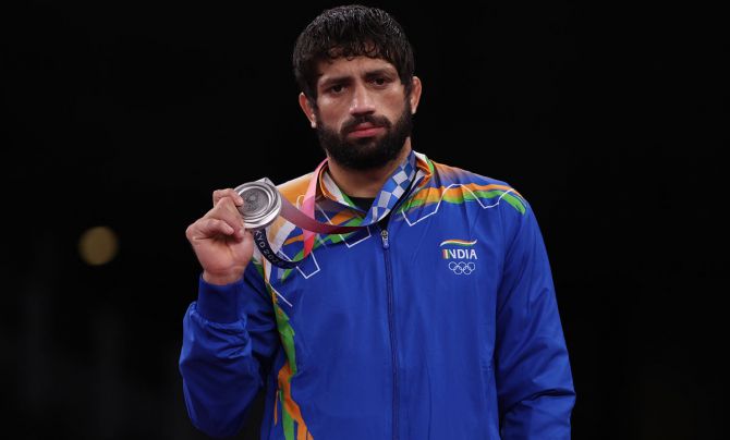 India's Ravi Kumar Dahiya poses with his silver medal from the men's  57kg Olympics Freestyle wrestling during the victory ceremony, at Makuhari Messe Hall in Chiba, Japan, on Thursday. 