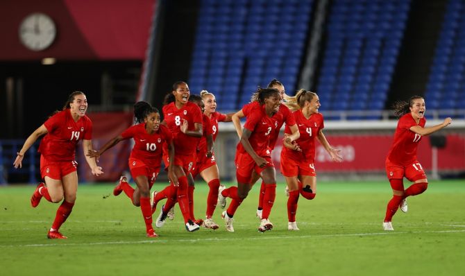 Canada's players celebrate winning the penalty shoot-out against Sweden in the Olympics women's football final, at International Stadium in Yokohama, on Friday. 