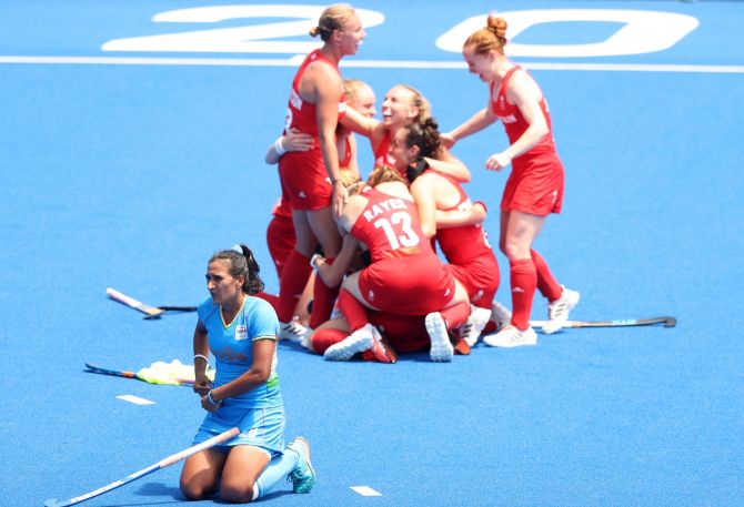 India's Rani Rampal is devastated while Great Britain's players celebrate winning the Olympics women's hockey bronze medal.