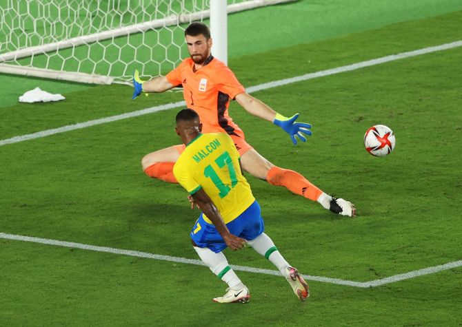 Malcom scores past Spain's goalkeeper Unai Simon in extra-time to put Brazil ahead. 