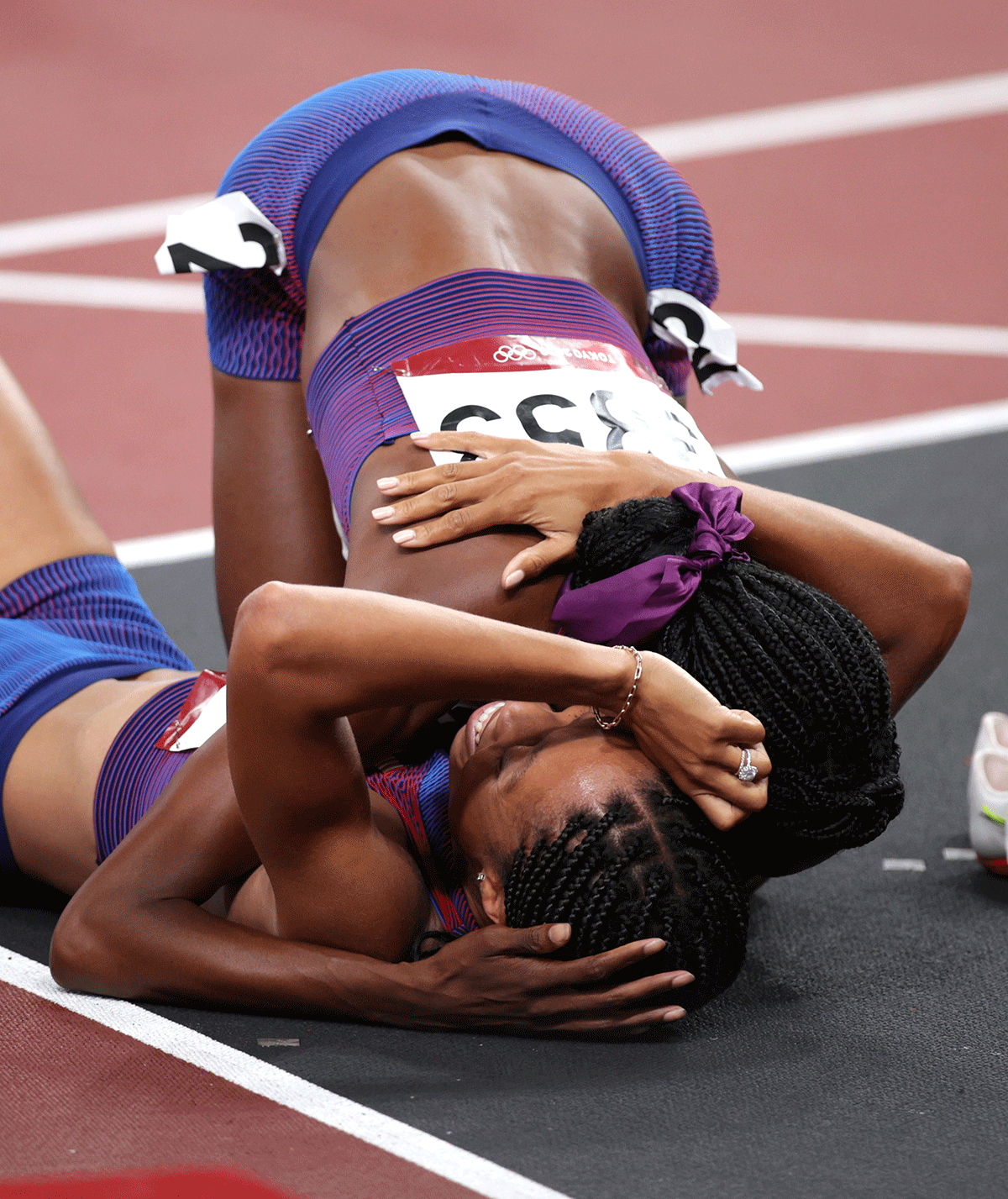 USA's Allyson Felix and Quanera Hayes hug after the race