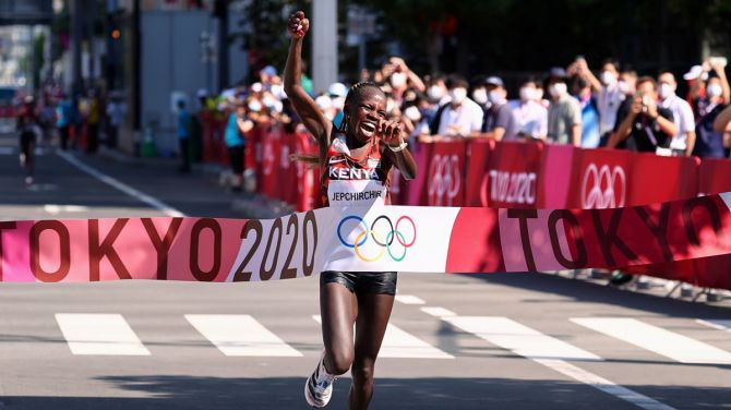 Kenya's Peres Jepchirchir celebrates as she breasts the tape first in the Olympics women's marathon, at Sapporo Odori Park, in Sapporo, Japan, on Saturday.