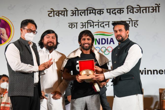 Wrestler Bajrang Punia receives a shawl and memento from Union Minister of Youth Affairs & Sports Anurag Thakur