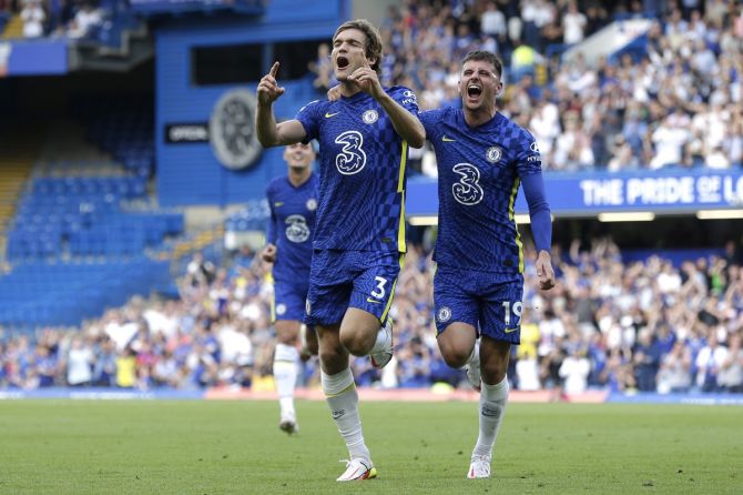 Marcos Alonso celebrates with teammate Mason Mount after scoring Chelsea's first goal against Crystal Palace, at Stamford Bridge in London, on Saturday. 