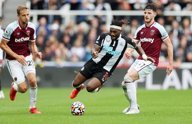Newcastle United's Allan Saint-Maximin is fouled by West Ham United's Declan Rice.