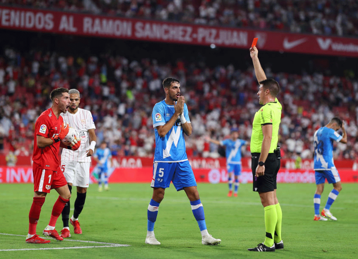 Rayo Vallecano's Luca Zidane is shown a red card and sent off by referee Isidro Diaz de Mera Escuderos as teammate Alejandro Catena looks on during the La Liga match against Sevilla FC at Estadio Ramon Sanchez Pizjuan in Seville on Sunday 