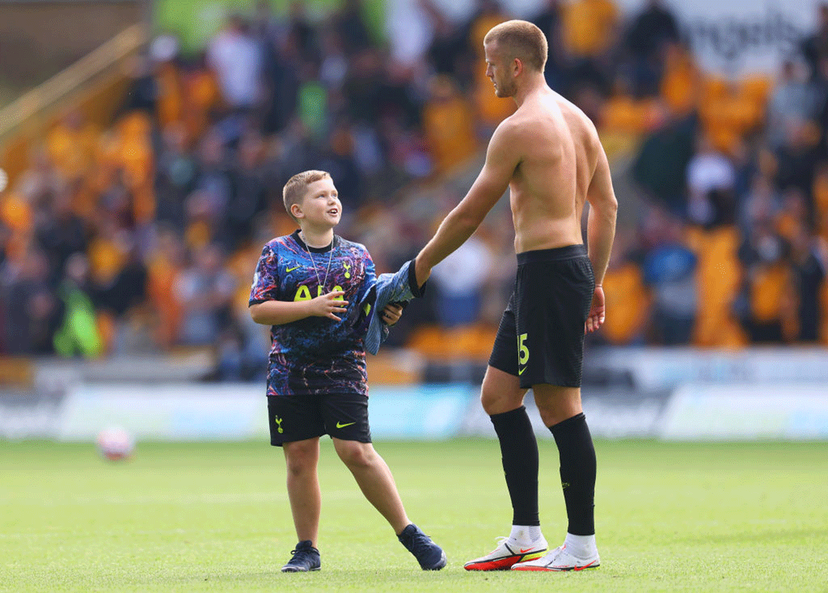 A young pitch invader receives a jersey from Tottenham Hotspur's Eric Dier after the match against Wolverhampton Wanderers at Molineux in Wolverhampton
