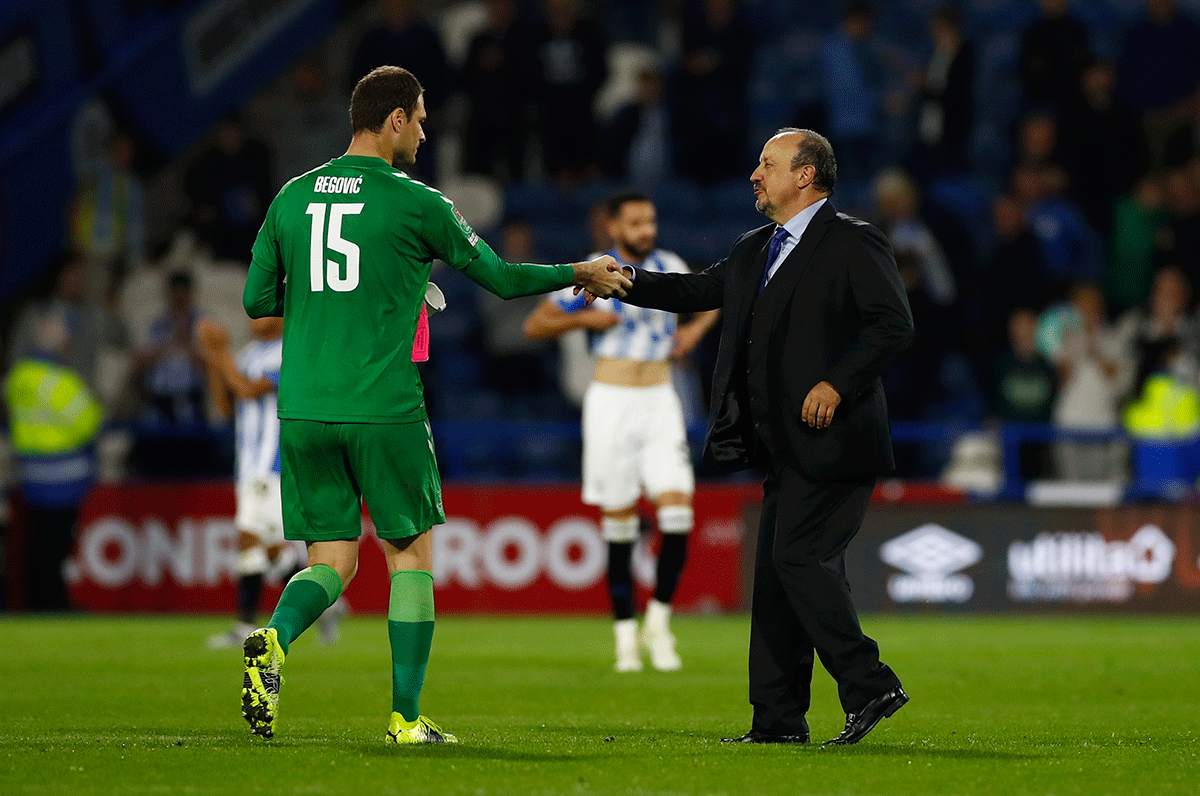 Everton manager Rafael Benitez shakes hands with Asmir Begovic after the match against Huddersfield Town at John Smith's Stadium in Huddersfield on Tuesday 