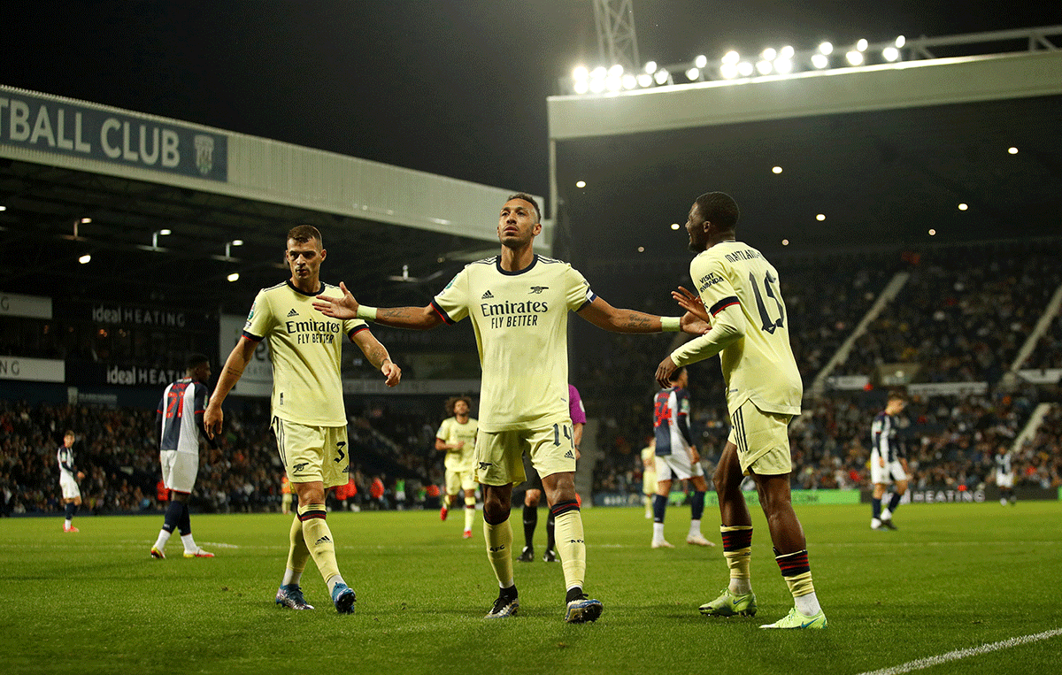 Arsenal's Pierre-Emerick Aubameyang celebrates scoring their fifth goal and his hat-trick with Granit Xhaka and Ainsley Maitland-Niles during their match at The Hawthorns, West Bromwich, on Wednesday 