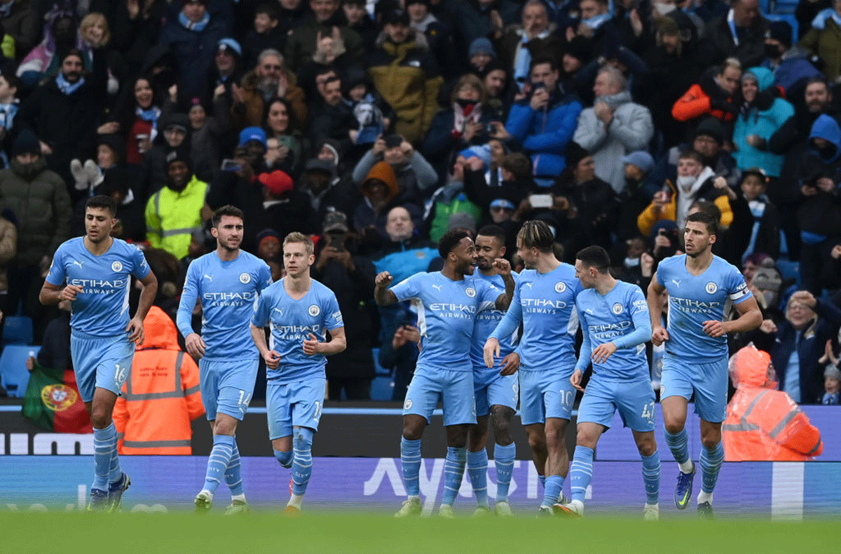 Manchester City's Raheem Sterling celebrates with teammates after scoring from the penalty spot against Wolverhampton Wanderers during the Premier League match at Etihad Stadium in Manchester on Saturday