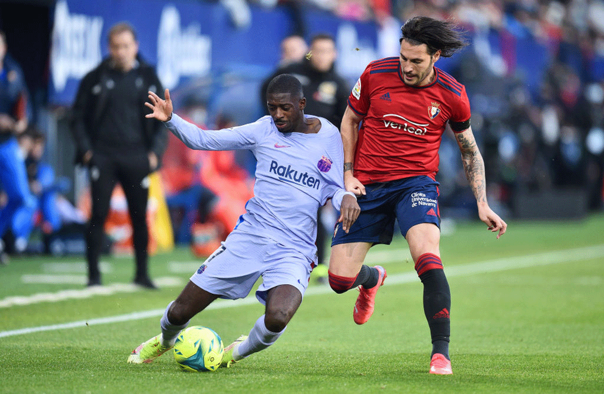 FC Barcelona's Ousmane Dembele battles for possession with Osasuna's Juan Cruz