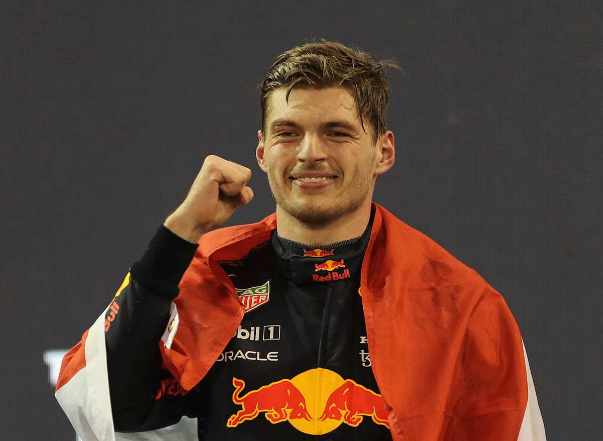 Max Verstappen celebrates on the podium after winning the 2021 F1 title in Abu Dhabi on Sunday