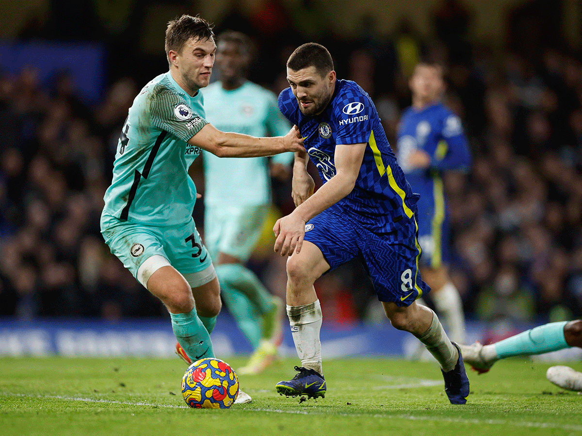 Chelsea's Mateo Kovacic is challenged by Brighton & Hove Albion's Joel Veltman as they vie for possession 