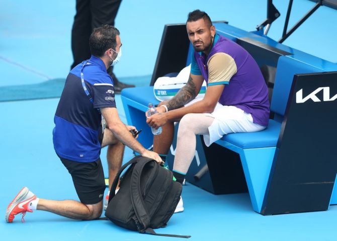 Australia's Nick Kyrgios reacts while receiving medical attention during his match against Croatia's Borna Coric