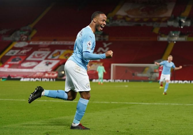 Raheem Sterling celebrates after scoring Manchester City's third goal.