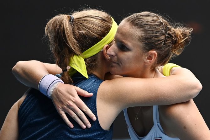 The Czech Republic's Karolina Muchova hugs compatriot Karolina Pliskova at the net following victory in their women's singles third round match on Saturday.