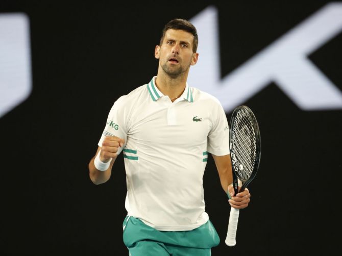 Serbia's Novak Djokovic celebrates winning his fourth round match against Canada's Milos Raonic
