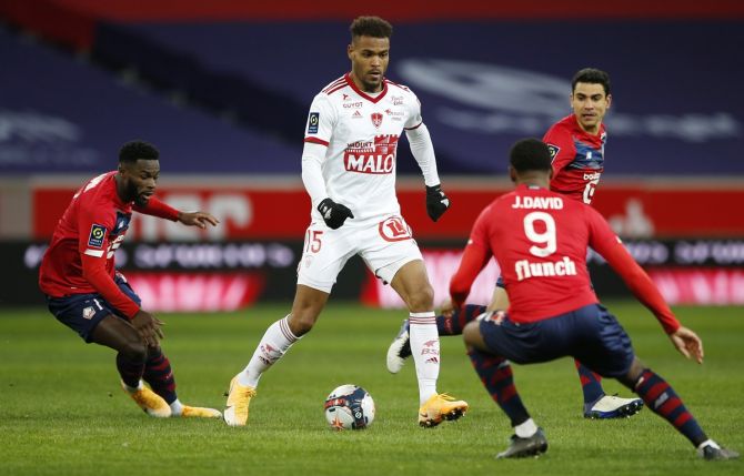 Brest's Steve Mounie tries to make his way past Lille's Jonathan David in Sunday's Ligue 1 match.
