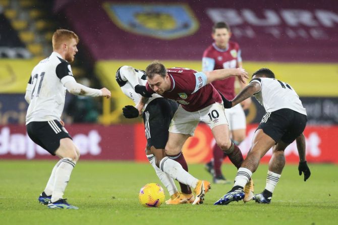 Burnley's Ashley Barnes in action with Fulham's Josh Maja, Mario Lemina and Harrison Reed during the Premier League match at Turf Moor, Burnley