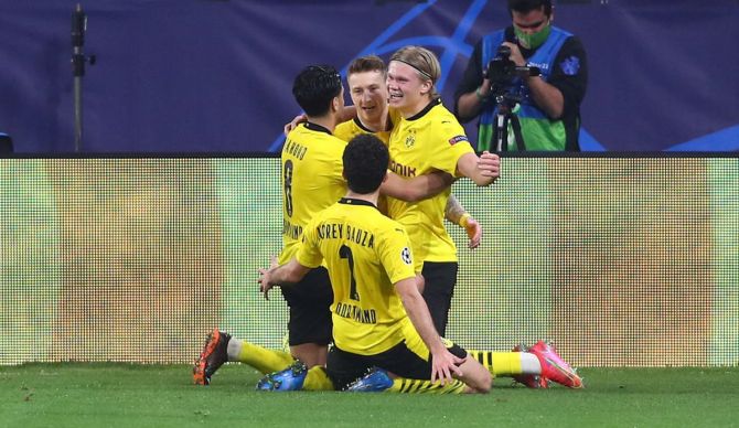 Borussia Dortmund's Erling Haaland (right) celebrates with Marco Reus and other team mates after scoring the third goal against Sevilla FC during their UEFA Champions League Round of 16 match at Estadio Ramon Sanchez Pizjuan in Seville