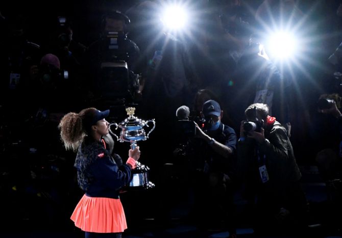 Japan's Naomi Osaka poses with the trophy after winning her final match against Jennifer Brady 