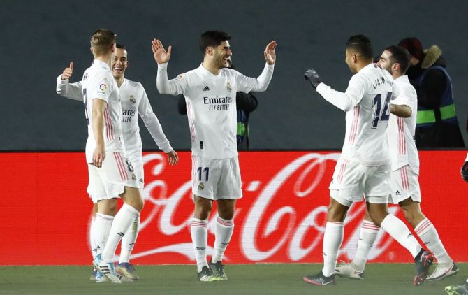 Real Madrid's Marco Asensio celebrates with teammates on scoring their second goal against Celta Vigo at Estadio Alfredo Di Stefano, Madrid in La Liga on Saturday.
