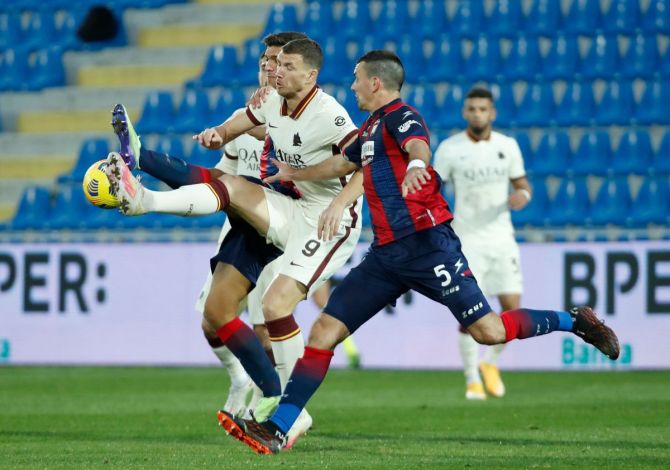 AS Roma's Edin Dzeko in action with Crotone's Vladimir Golemic during their match at Stadio Ezio Scida in Crotone on Wednesday.
