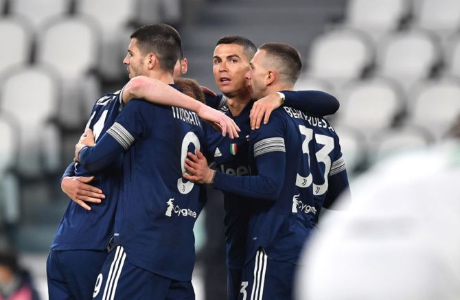 Cristiano Ronaldo is congratulated by teammates Dejan Kulusevski, Alvaro Morata and Federico Bernardeschi after scoring Juventus's third goal during the Serie A match against Sassuolo