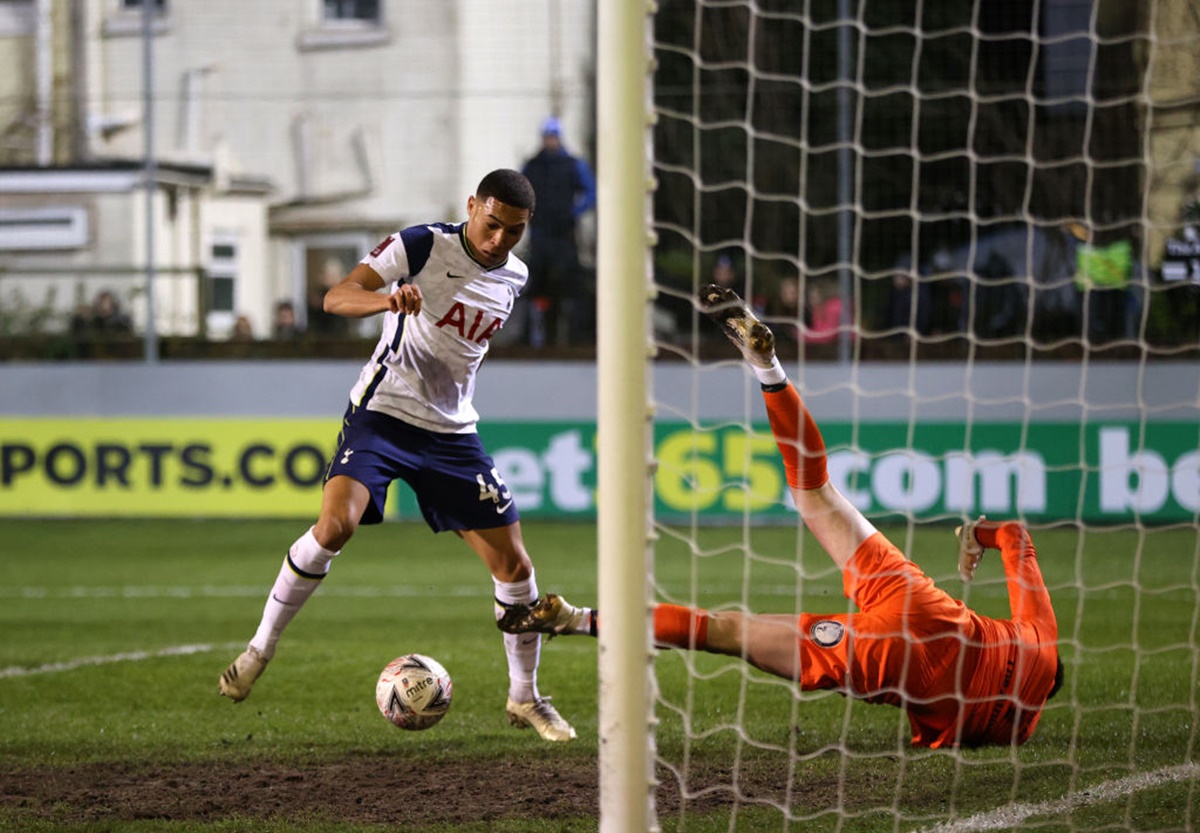 Carlos Vinicius takes the ball around goalkeeper Bayleigh Passant of Marine to score Tottenham Hotspur's first goal.