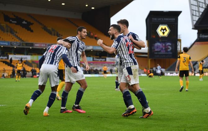 West Bromwich Albion players celebrate after the match against Wolverhampton Wanderers in their English Premier League derby at Molineux Stadium in Wolverhampton on Saturday