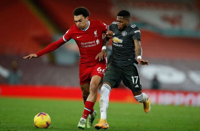 Liverpool's Trent Alexander-Arnold battles for possession with Manchester United's Fred during their English Premier League match at Anfield on Sunday.