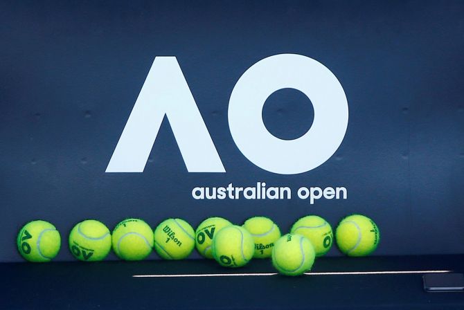 Tennis balls are pictured in front of the Australian Open logo before the tennis tournament