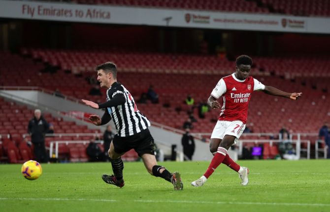 Bukayo Saka scores Arsenal's second goal past Newcastle United's Ciaran Clark.
