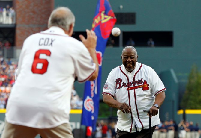 Atlanta Braves legend Hank Aaron throws the ceremonial first pitch to former manager Bobby Cox prior to the first MLB game at SunTrust Park in Atlanta, Georgia on April 14, 2017.