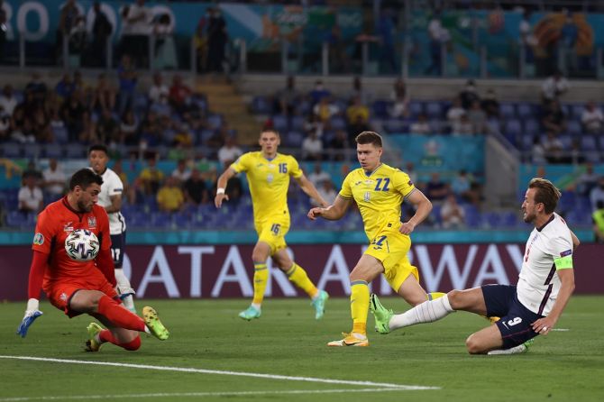 Harry Kane scores past Ukraine's Georgiy Bushchan to put England ahead in the match