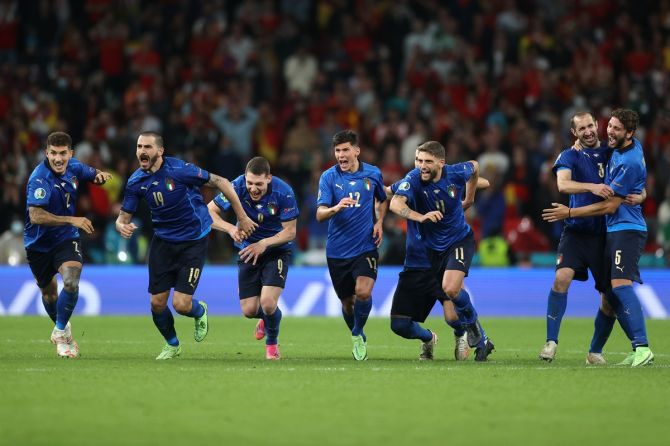 Italy's players celebrate after winning the penalty shoot-out 