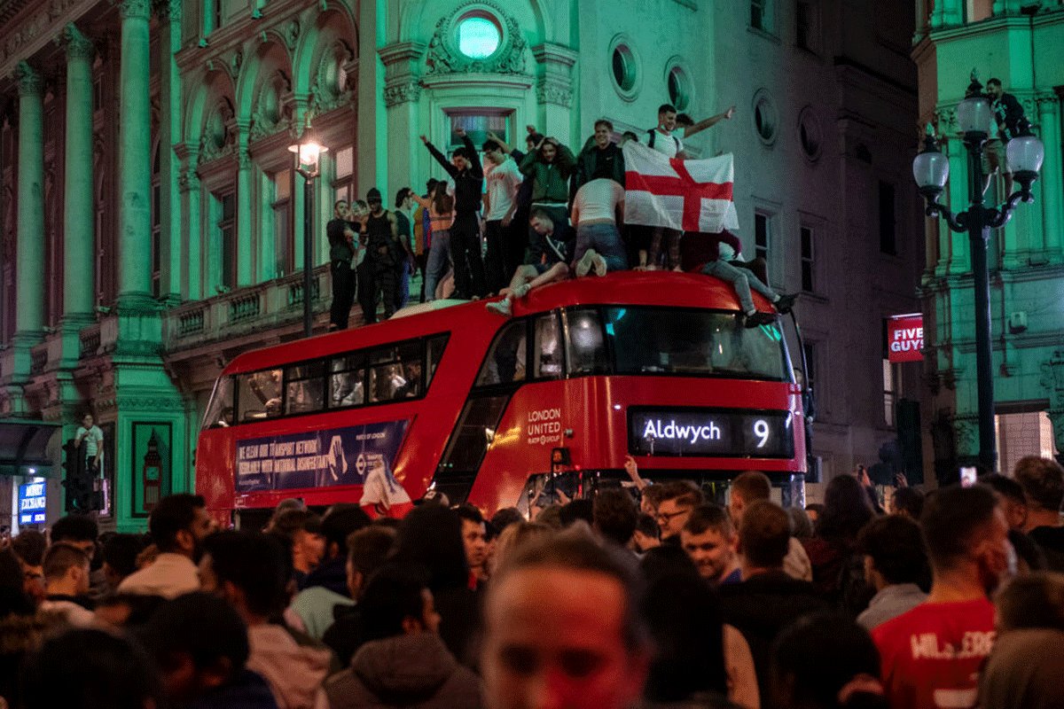 England football fans celebrate in the streets surrounding Piccadilly and Leicester Square 
