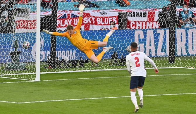 England goalkeeper Jordan Pickford makes a vain attempt to prevent Mikkel Damsgaard's free-kick crashing into the net.